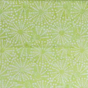 May include: A close-up of a light green fabric with a repeating pattern of white, dotted starburst designs. The fabric has a slightly textured appearance and a soft, pastel color palette.