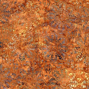 May include: Close-up of a fabric with an intricate floral pattern. The fabric has a warm orange background with a detailed design in shades of blue, gold, and brown. The pattern is repeated throughout the fabric.
