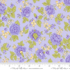 May include: Floral fabric with a light purple background. The fabric features large purple flowers, smaller yellow flowers, and green leaves. The fabric has a repeating pattern of flowers and leaves. The bottom of the fabric has a ruler with the word "moda" printed on it.