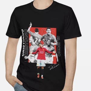 May include: Black t-shirt featuring a graphic of Cristiano Ronaldo in a red soccer uniform, with the text "CRISTIANO" and "EL BICHIO". The design includes multiple images of Ronaldo in action, with his signature.