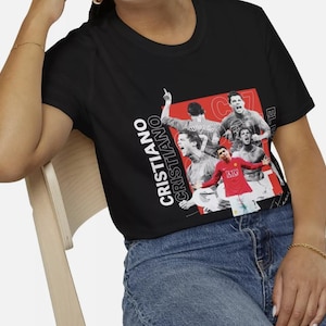 May include: Black t-shirt featuring a collage of Cristiano Ronaldo in action, with the name "CRISTIANO" in white text. The design includes images of Ronaldo in a red jersey and other action shots.