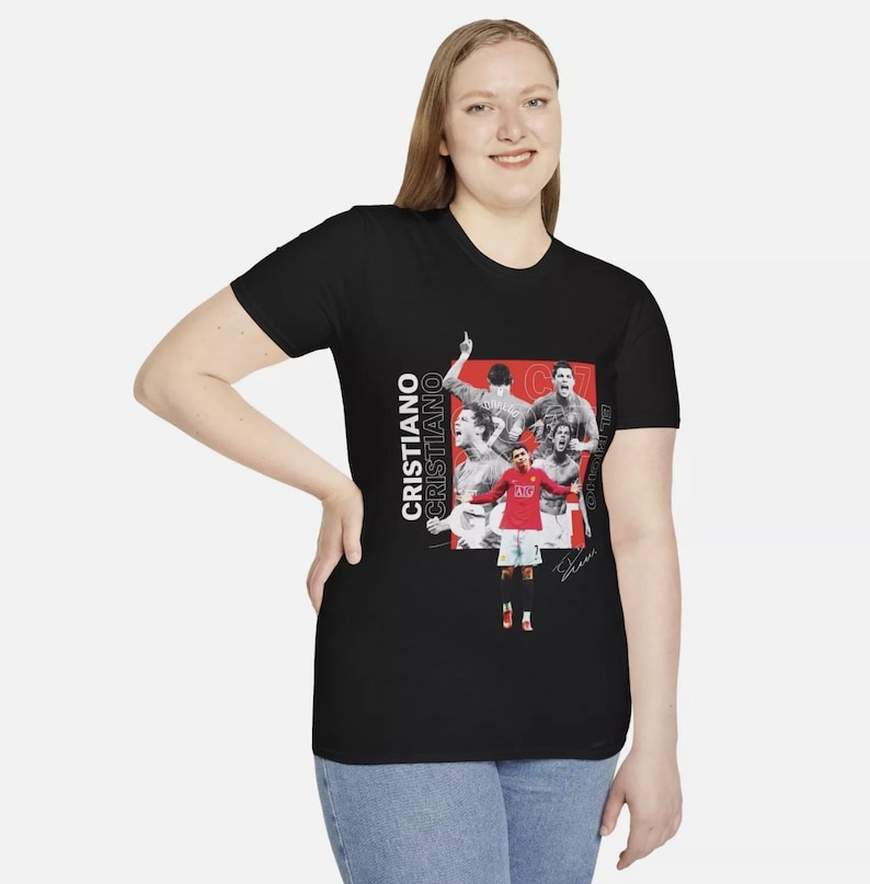 May include: Black t-shirt featuring a collage of images of Cristiano Ronaldo in action, with the name "Cristiano" printed vertically in white. The design includes a signature and red accents.