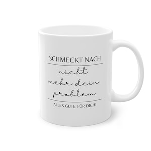 May include: White ceramic mug with black text that reads "Schmeckt nach nicht mehr dein problem. Alles Gute f&uuml;r dich!"