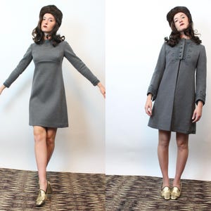 May include: Two images side-by-side of a woman wearing a gray dress and a matching hat. The dress is long-sleeved and knee-length. The woman is also wearing gold shoes. The dress on the right has buttons down the front.