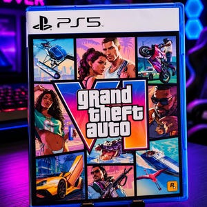 May include: A PlayStation 5 video game case for Grand Theft Auto VI. The cover art features a collage of characters, a yellow sports car, a motorcycle, a boat, a flamingo, and an alligator, with the title text Grand Theft Auto VI in the center.