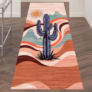 May include: A rectangular runner rug with a desert landscape design. The rug features a large blue cactus in the center, a sun, and layered earth-tone colors. The rug is designed to be placed in a hallway or entryway.
