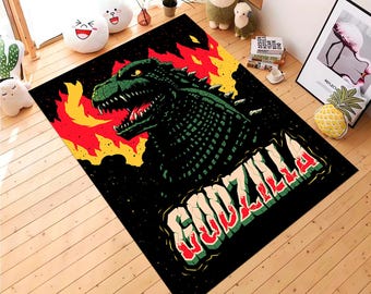May include: Black rectangular area rug featuring a green Godzilla illustration with red and yellow flames. The word "GODZILLA" is written in large, stylized letters in red, green, and yellow.