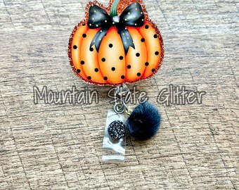 Polka dot pumpkin with bow acrylic badge reel