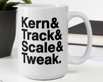 May include: White ceramic mug with black text that reads "Kern & Track & Scale & Tweak."