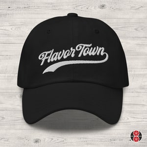 May include: Black baseball cap with white embroidered text that reads "Flavor Town".