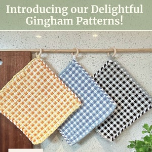 May include: Three gingham patterned pot holders hanging on a wooden rod. The pot holders are yellow and white, blue and white, and black and white.
