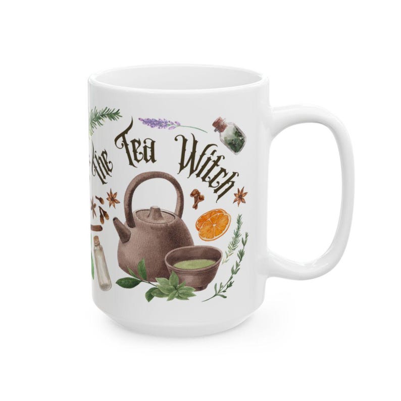 May include: White ceramic mug with a brown teapot, green teacup, and various herbs and spices. The text "The Tea Witch" is written in a decorative font.