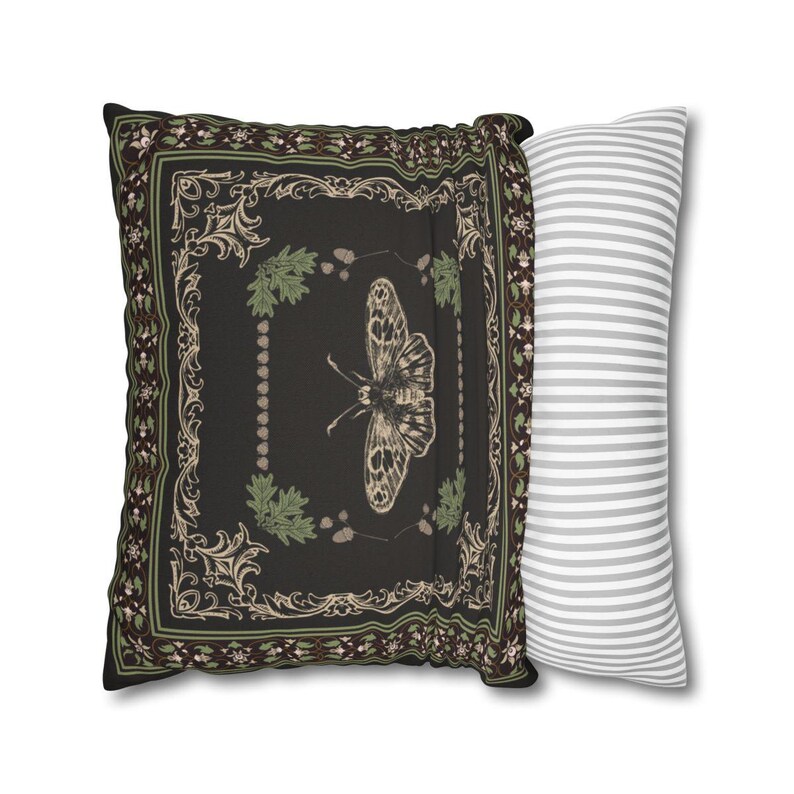 May include: A black and green decorative pillow with a butterfly design and a white and gray striped pillow.