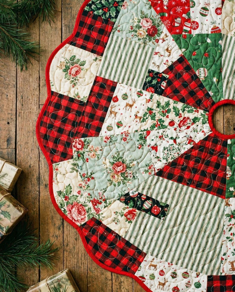 May include: A circular quilted Christmas tree skirt featuring a patchwork design of red and black buffalo plaid, green and white stripes, and cream fabric with floral, reindeer, and holiday ornament prints, finished with a red scalloped edge.