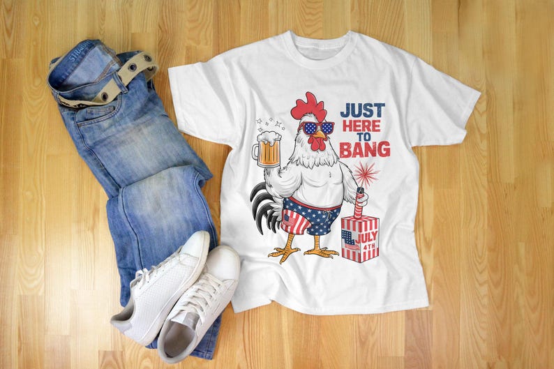 May include: White t-shirt with a cartoon rooster wearing sunglasses and holding a beer. The rooster is wearing red, white, and blue swim trunks and holding a firework. The text "Just Here To Bang" is printed on the shirt.