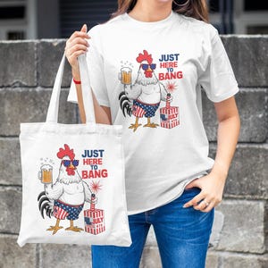 May include: White tote bag with a red, white, and blue rooster holding a beer and a firework. The text on the bag reads "Just Here To Bang".