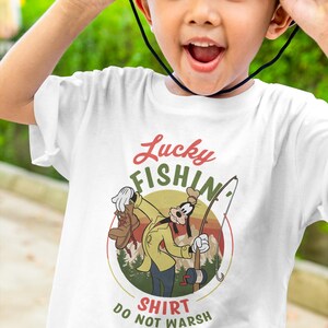 May include: White t-shirt with a cartoon image of Goofy fishing. The image is in a circle with the text "Lucky Fishin' Shirt Do Not Wash" below it.