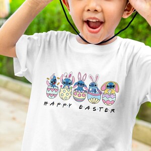 May include: A white t-shirt with a graphic of five blue Stitch characters wearing bunny ears and sitting in Easter eggs. The text "HAPPY EASTER" is printed below the characters.