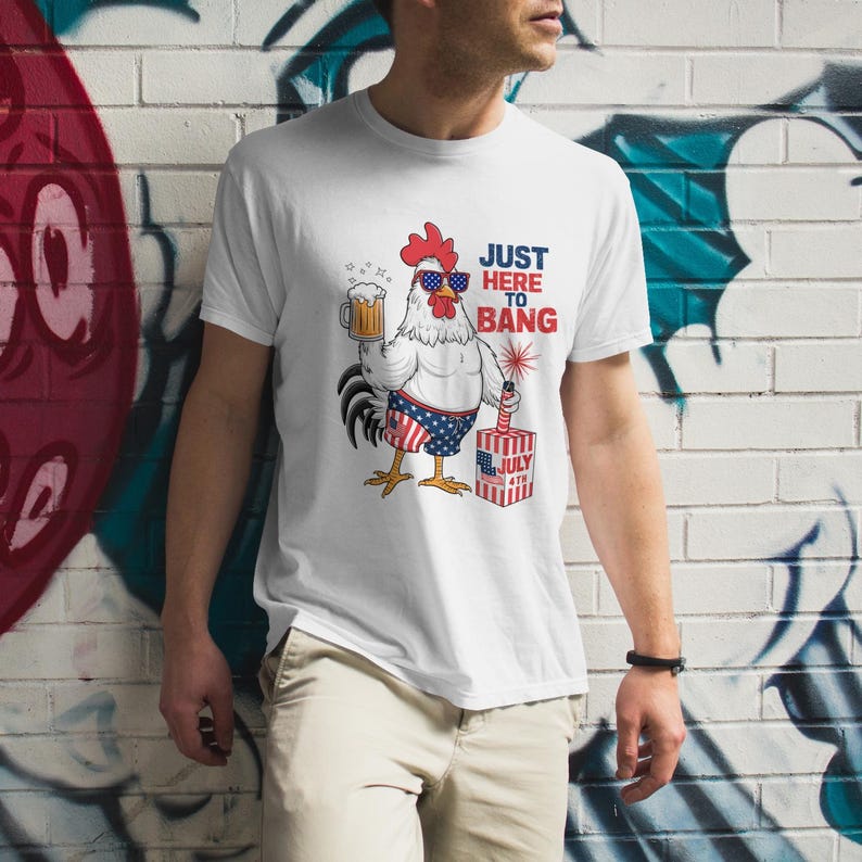 May include: White t-shirt with a cartoon rooster wearing sunglasses and holding a beer. The rooster is wearing red, white, and blue swim trunks and holding a firework. The text "Just Here To Bang" is printed on the shirt.