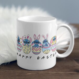 May include: White ceramic mug with a colorful design of Stitch characters from Lilo & Stitch dressed as Easter bunnies and holding Easter eggs. The text "Happy Easter" is printed on the mug.