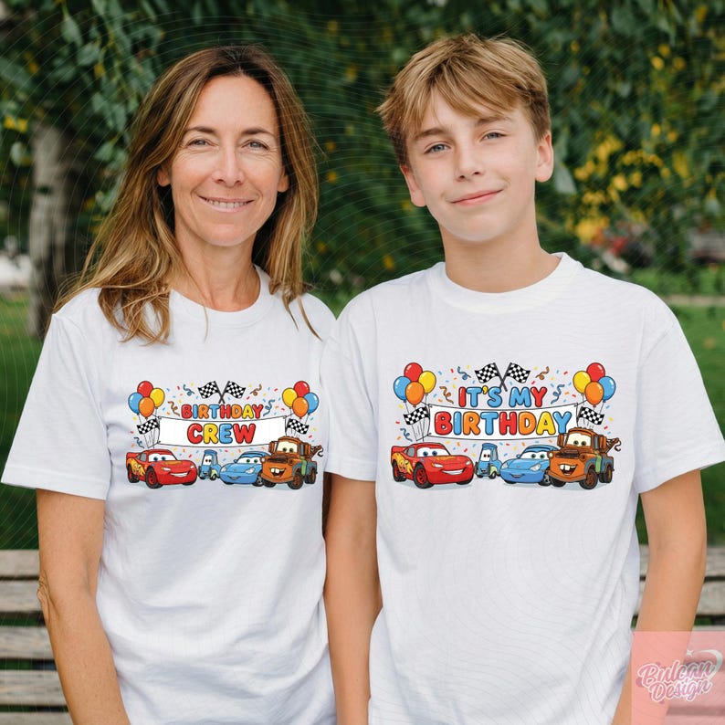 May include: Two white t-shirts with colorful graphics featuring cartoon cars, balloons, and checkered flags. One shirt says "BIRTHDAY CREW," the other says "IT'S MY BIRTHDAY." The shirts are worn by a woman and a boy.