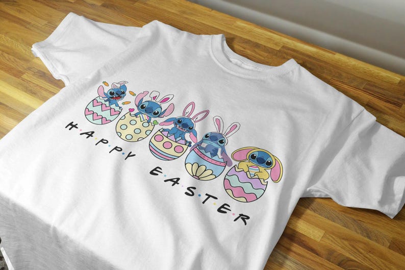 May include: White t-shirt with a graphic of Stitch characters from Lilo & Stitch in Easter egg baskets. The text "Happy Easter" is printed below the characters.