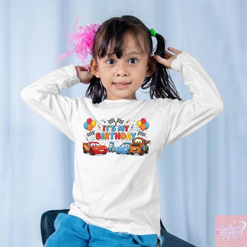 May include: A white ceramic mug with a black handle and the text "But First, Coffee" in a handwritten style. The mug is on a white surface. The mug is likely for hot beverages.