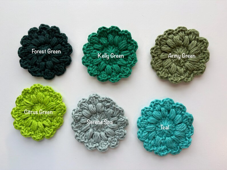 May include: Six circular crochet flower appliques arranged in two rows. The colors are labeled as Forest Green, Kelly Green, Army Green, Citrus Green, Serene Spa, and Teal. Each piece features a textured, puff-stitch design with scalloped edges.