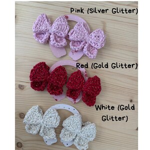 May include: Cotton glitter bows in pink, red, and white. The pink bows have silver glitter, the red bows have gold glitter, and the white bows have gold glitter. Each bow is attached to a decorative card.