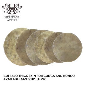 May include: A collection of six circular, tan buffalo thick skins for conga and bongo drums. The skins vary slightly in color and texture. Text at the bottom reads "BUFFALO THICK SKIN FOR CONGA AND BONGO AVAILABLE SIZES 10" TO 24". The Heritage Attire logo is in the upper left.