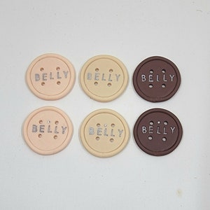 May include: Six round, fabric-covered buttons with the word "BELLY" printed in silver on each. The buttons are in three colors: beige, light brown, and dark brown.