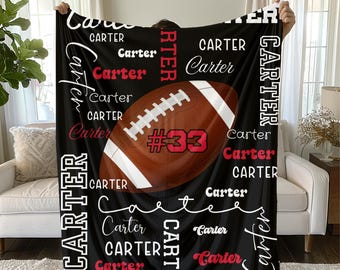 May include: Black fleece blanket featuring a football graphic with the name "Carter" in various fonts and sizes. The football is brown with white stripes and the number "33". The name "Carter" is also in red.