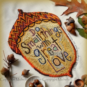 May include: A needlepoint design of an acorn with the text "Do small things with great love" stitched in colorful thread. The design is surrounded by acorns and leaves.