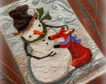 May include: A needlepoint rug depicting a snowman with a brown hat and green scarf, holding a red fox with a purple bow. The rug is set against a blue and white background with a swirling pattern. The text "Woodland Snowman & Fox" is visible at the bottom of the rug.