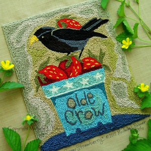 May include: A needlepoint rug featuring a black bird perched on a blue pot with white stars. The pot is labelled "Olde Crow" and surrounded by red strawberries. The background is a textured beige.