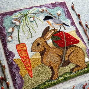 May include: A needlepoint artwork featuring a brown rabbit with a red and green mushroom on its back, a carrot, and a small bird. The artwork is framed with a purple border and has the text "Copyright 2019 Michelle L. Palmer and Chickadee Go Gathering @2019 Michelle L. Palmer" at the bottom.