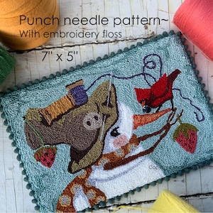 May include: A punch needle pattern with embroidery floss, featuring a whimsical design of a donkey and a snowman with a red bird and strawberries. The finished piece measures 7 x 5 inches.