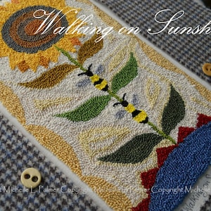 May include: A needlepoint design of a sunflower with two bees on a stem. The background is white and the design is in shades of yellow, green, red, and blue. The text "Walking on Sunshine" is visible at the top of the design.