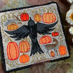 May include: A needlepoint cushion featuring a black crow with outstretched wings, surrounded by orange pumpkins and vines. The background is a light grey with a brown border. The text "Copyright Michelle L. Palmer" is at the bottom of the cushion.
