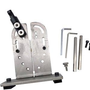 May include: A metal knife sharpening system with a silver finish. The system includes a main bracket, a black adjustable arm, several hex keys, and other small components. The base has black rubber feet.