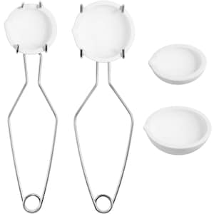 May include: Two white ceramic crucibles with metal handles, and two additional white ceramic crucibles. The crucibles are used for melting and heating materials in a laboratory setting.
