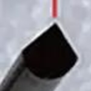 May include: A black metal rod with a rounded end, positioned at a 90 degree angle. A red laser beam is shining on the rod.