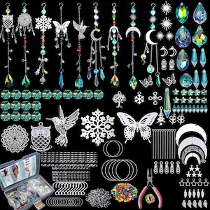 May include: A collection of sun catchers and crafting supplies. Includes crystal pendants, metal charms in various shapes like butterflies and moons, beads, chains, and tools. The color palette features clear, iridescent, and silver tones.