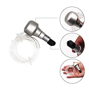 May include: A silver-colored dental tool with a black tip and a clear plastic tube. The tool has a rounded head and a cylindrical body. Additional close-up views show the tool's details, including the tip and the connection to the tube. The tool is held in a hand in one of the close-up views.