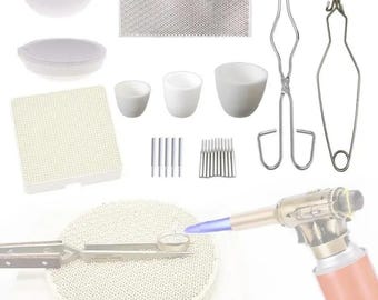 May include: A set of jewelry making tools including a torch, tweezers, ceramic crucibles, a ceramic tile, and a ceramic pad.