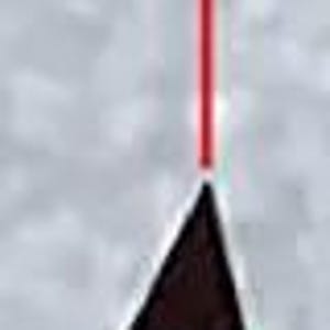 May include: A close-up of a red laser beam pointing at a 45-degree angle towards a silver metal object. The object is shaped like a triangle with a rounded tip.