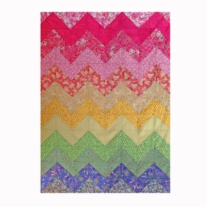 May include: A colorful chevron patterned quilt with a rainbow of colors, including pink, red, yellow, green, and purple.