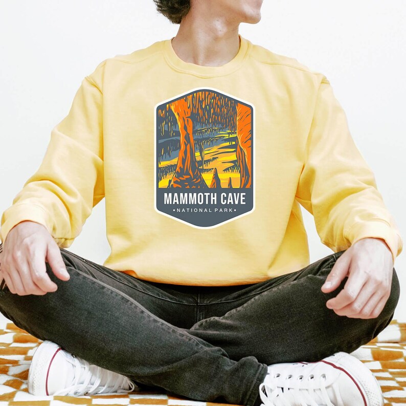 Unisex Mammoth Cave National Park sweatshirt featuring a relaxed fit, ribbed cuffs, and OEKO-TEX certified dyes. Made from durable, soft fabric with a fleece interior. Colors: Pepper, Terracotta, Butter, White, Blue Spruce, Blue Jean, and True Navy.