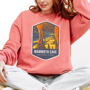 Unisex Mammoth Cave National Park sweatshirt featuring a relaxed fit, ribbed cuffs, and OEKO-TEX certified dyes. Made from durable, soft fabric with a fleece interior. Colors: Pepper, Terracotta, Butter, White, Blue Spruce, Blue Jean, and True Navy.