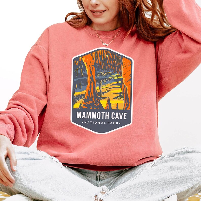 Unisex Mammoth Cave National Park sweatshirt featuring a relaxed fit, ribbed cuffs, and OEKO-TEX certified dyes. Made from durable, soft fabric with a fleece interior. Colors: Pepper, Terracotta, Butter, White, Blue Spruce, Blue Jean, and True Navy.